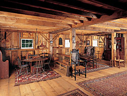 Choice examples of country seating in the barn are used for entertaining, with a sawbuck table in one setting and a hutch table in another.