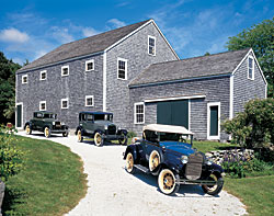 Antique furniture is not the only area in which this couple collects. A passion of the husband's includes their ten antique vehicles -- three of which are shown here -- a 1930 Ford, a 1929 Briggs, and a 1931 Ford Roadster. He enjoys finding antique cars in disrepair and restoring them to working order.