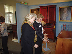 Director, Penny Hunt, and a trust member discuss a Vermont chest of drawers at the Bennington Museum on the 2006 symposium visit to the Berkshires.