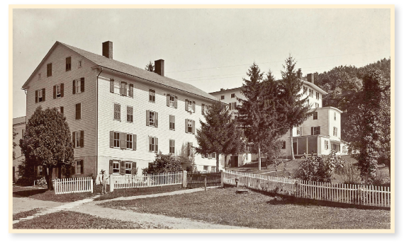 View of large Shaker buildings with a brother standing in front, from “Views of North Family Shakers at Mt. Lebanon, New York,” by J. E. West., No. 25 of the series, First and Second Houses.