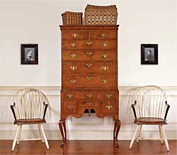 The owners wanted a Queen Anne high chest, and Olde Hope located this one in a private collection. Made of figured maple, it is from Rhode Island, circa 1740–1760, and is of an unusually small size with pleasingly narrow proportions. Flanking the high chest is a pair of circa-1800 Philadelphia bow-back Windsor chairs with original white paint, mahogany arms, leather seats, and branded “Cox” (from Northeast Auction’s Arthur Spector, 2004). Above the chairs is a fine pair of profile portraits in original frames of Mr. and Mrs. George Buckingham, Pennsylvania, circa 1830, attributed to Mr. Boyd. Surmounting the high chest are Native American Woodlands tribes baskets with original “swabbed” decoration.