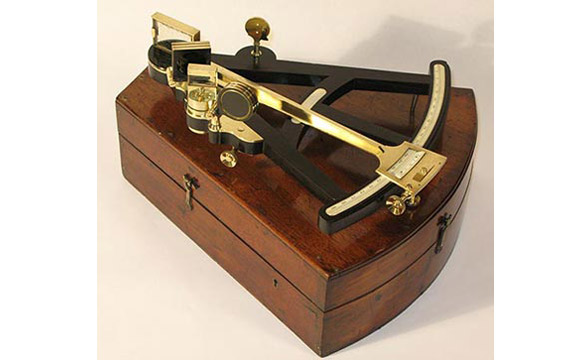 Early 19th century ebony octant with ivory scales, brass fittings, and the original mahogany box, labelled Henry Hughes, London