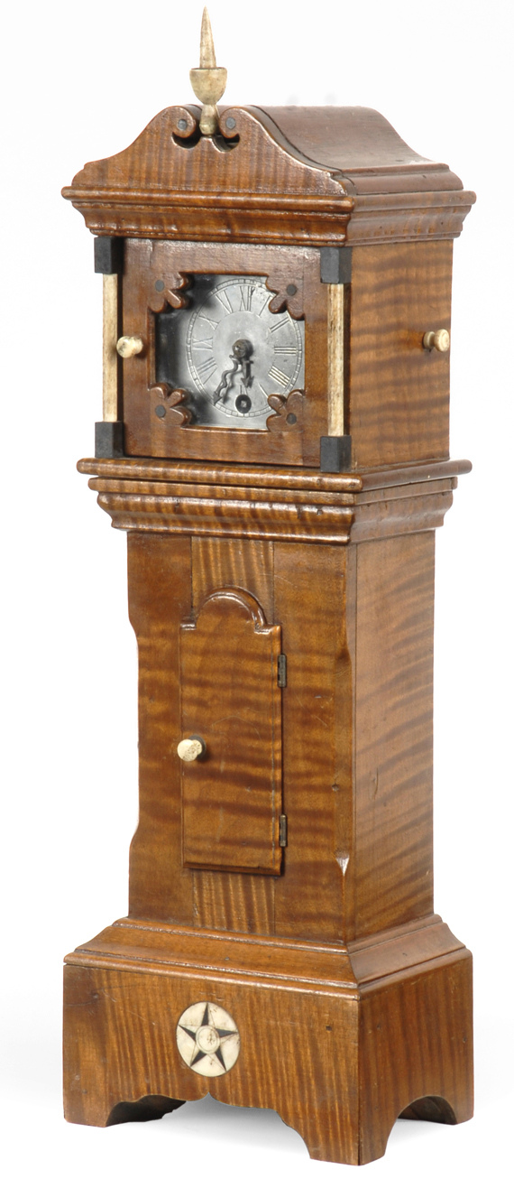 A rare folk art tiger maple and whale bone miniature tall case clock. The movement  signed by Charles W. Hurll, New Bedford,  Massachusetts, circa 1850-70.